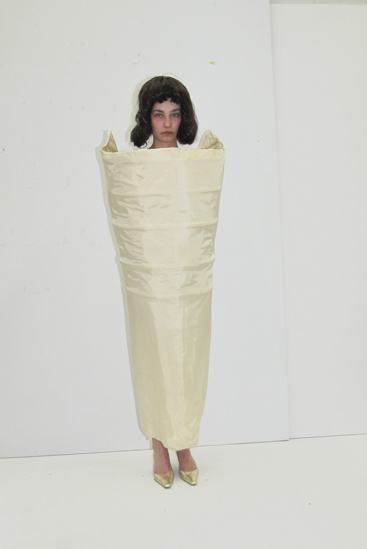 Photo of model wearing cone-shaped dress