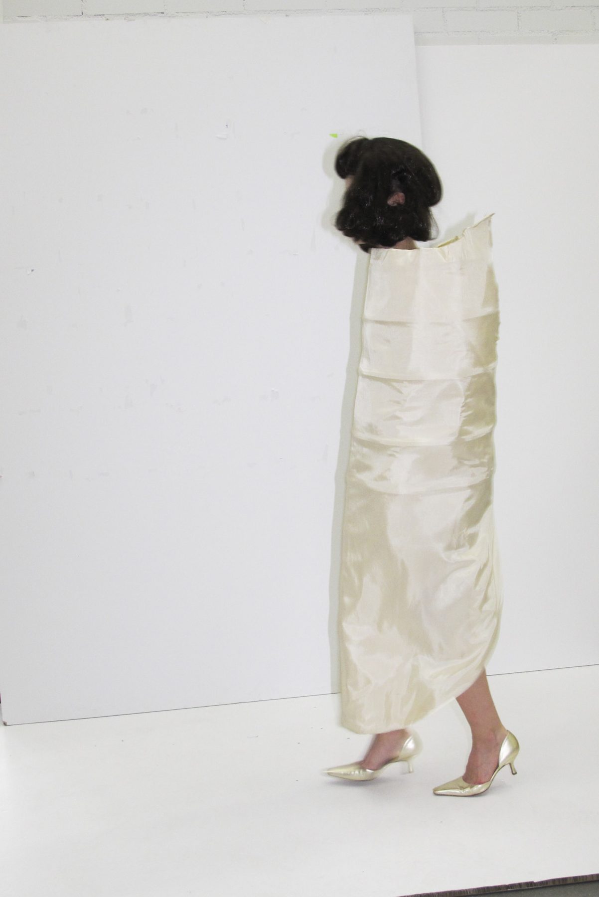 Photo of model walking in cone-shaped dress