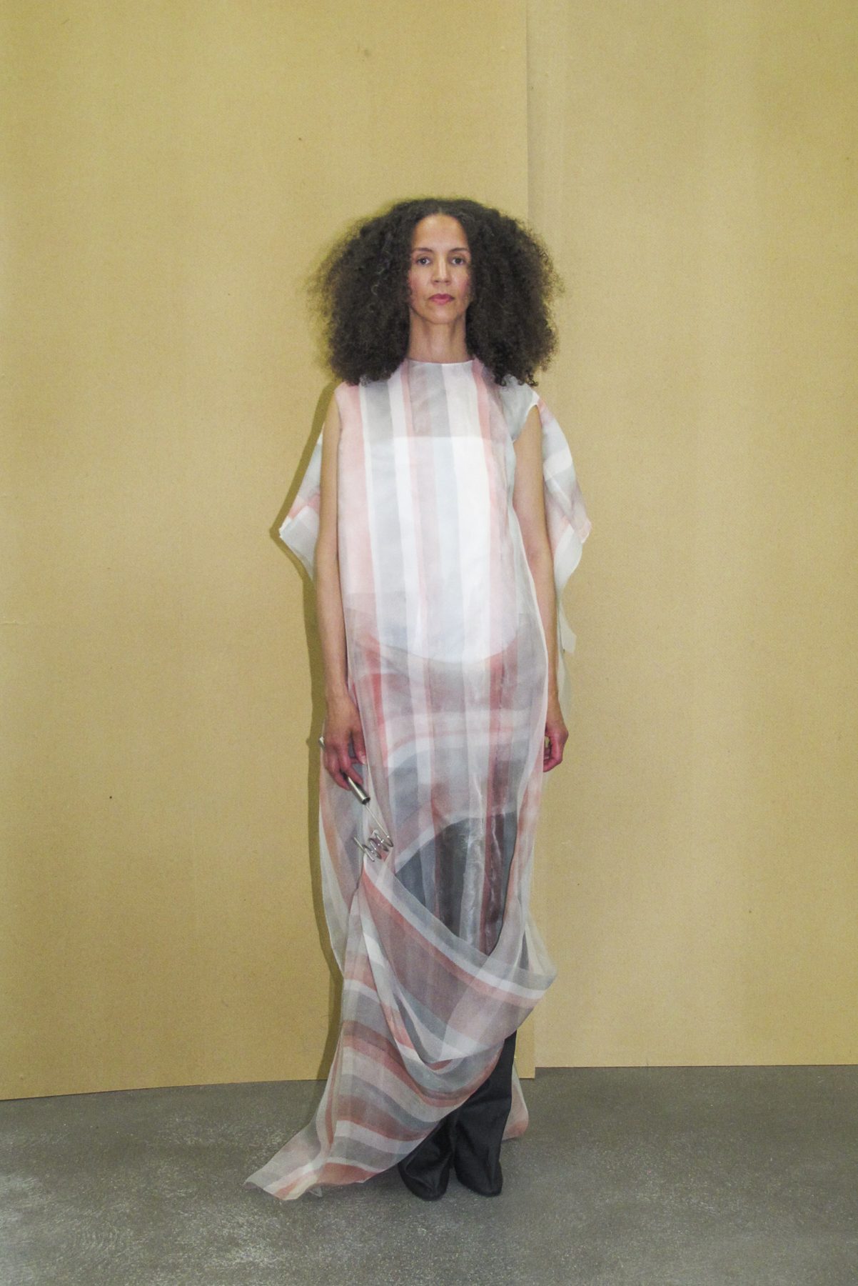 Photo of model wearing sheer draped striped dress