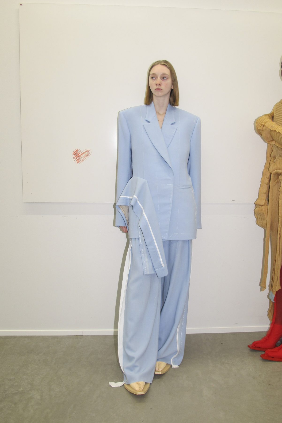 Model wearing light blue oversized tailored suit outfit