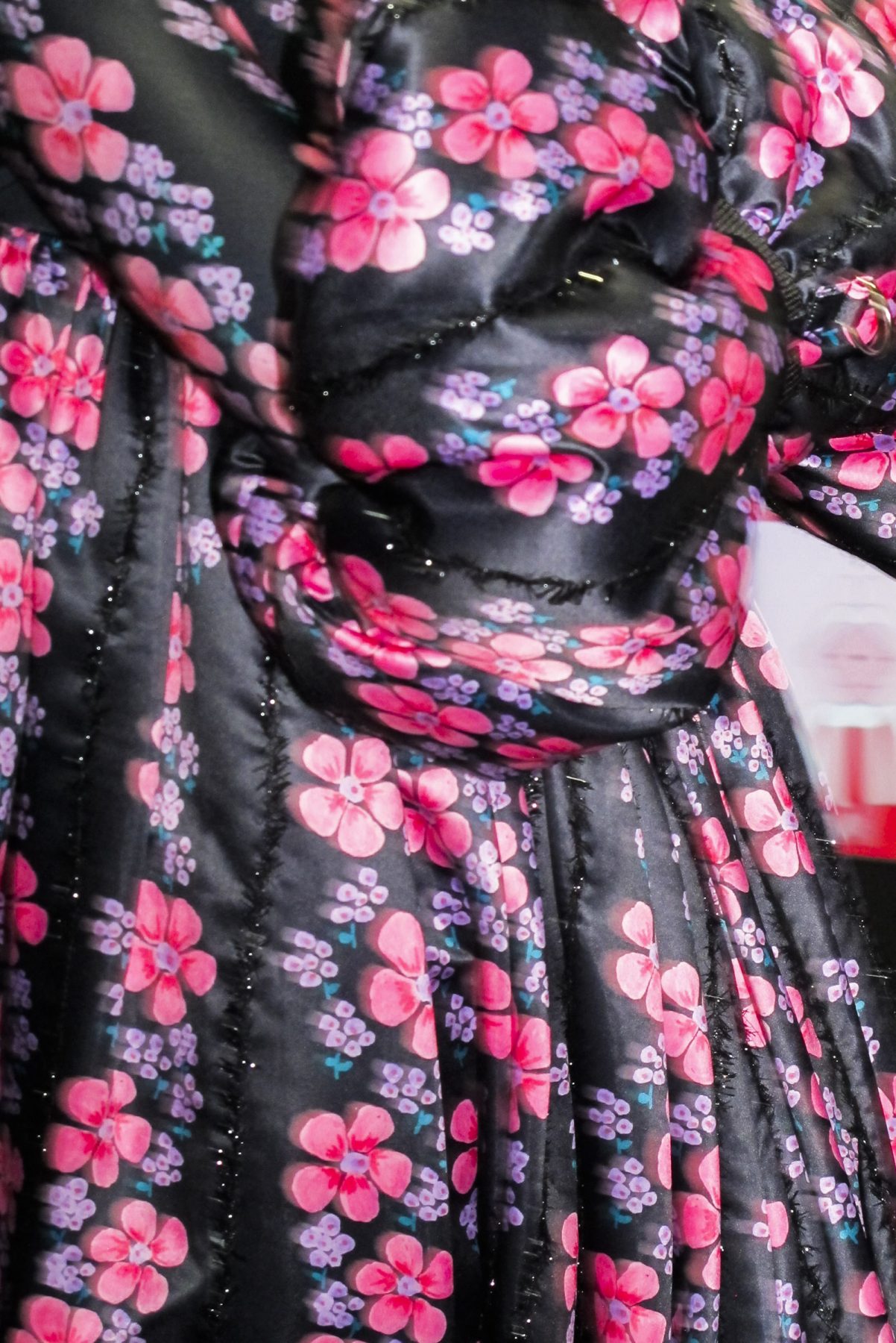 Close-up photo of black and pink puffy floral dress