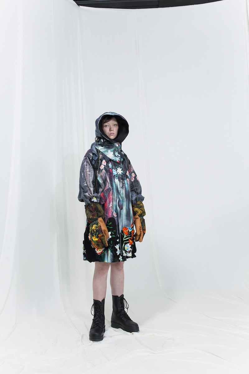 Model is wearing a melted floral parka with matching velvet skirt, hood and gloves