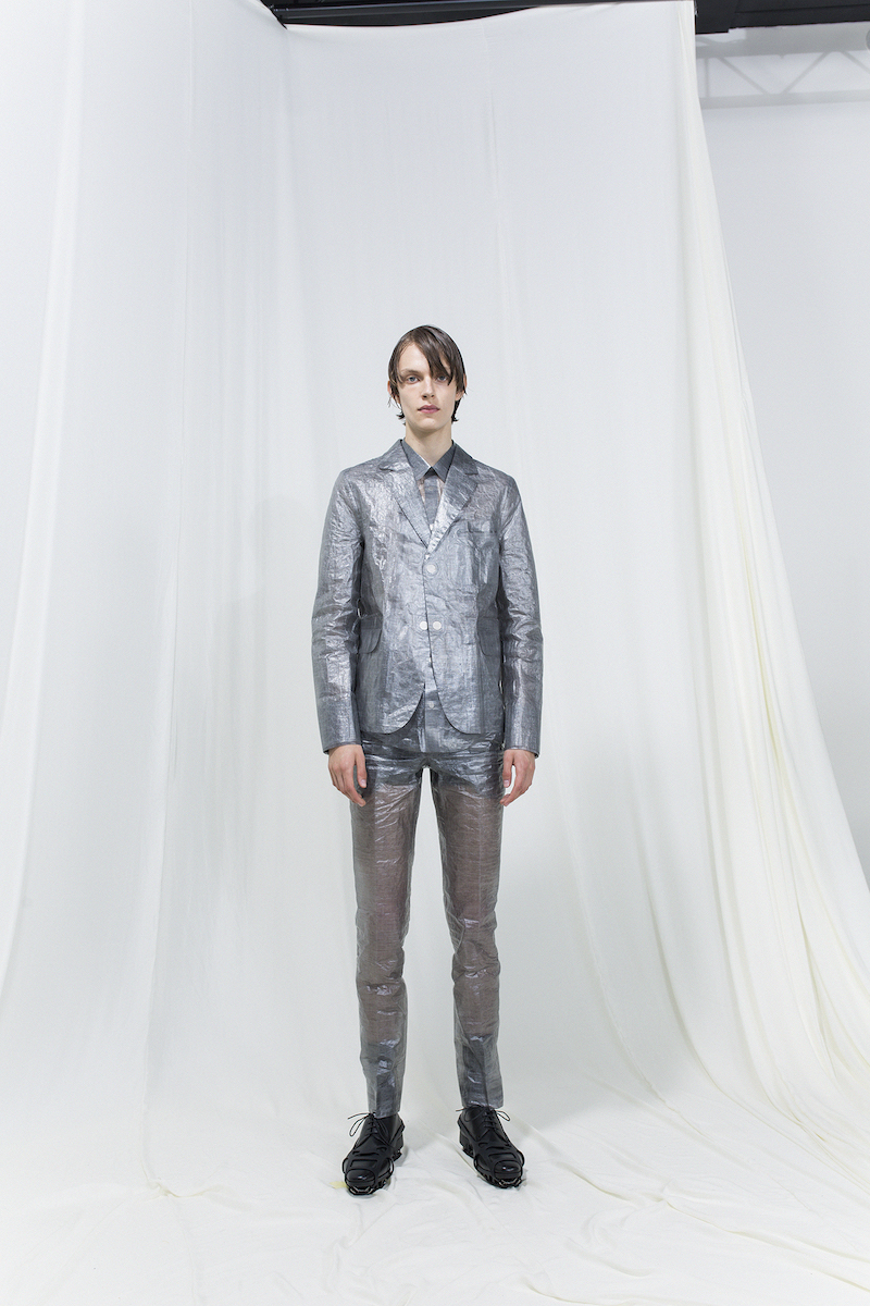 Model wearing silver suit jacket and matching trousers