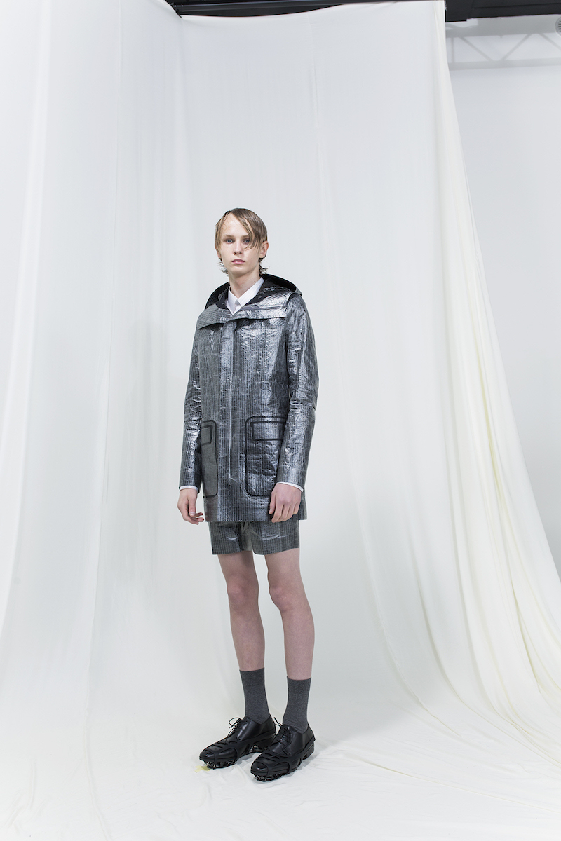 Model wearing silver jacket and silver shorts